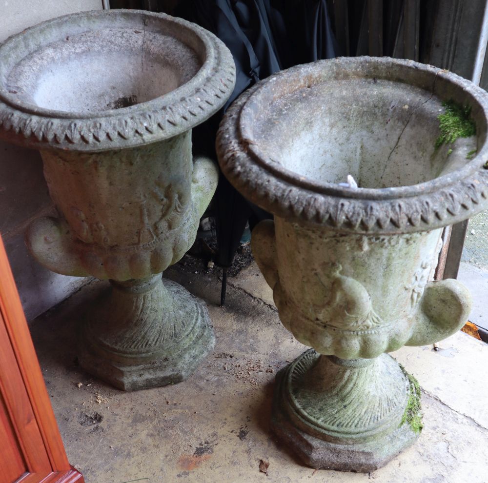 A pair of reconstituted stone garden urns, height 60cm